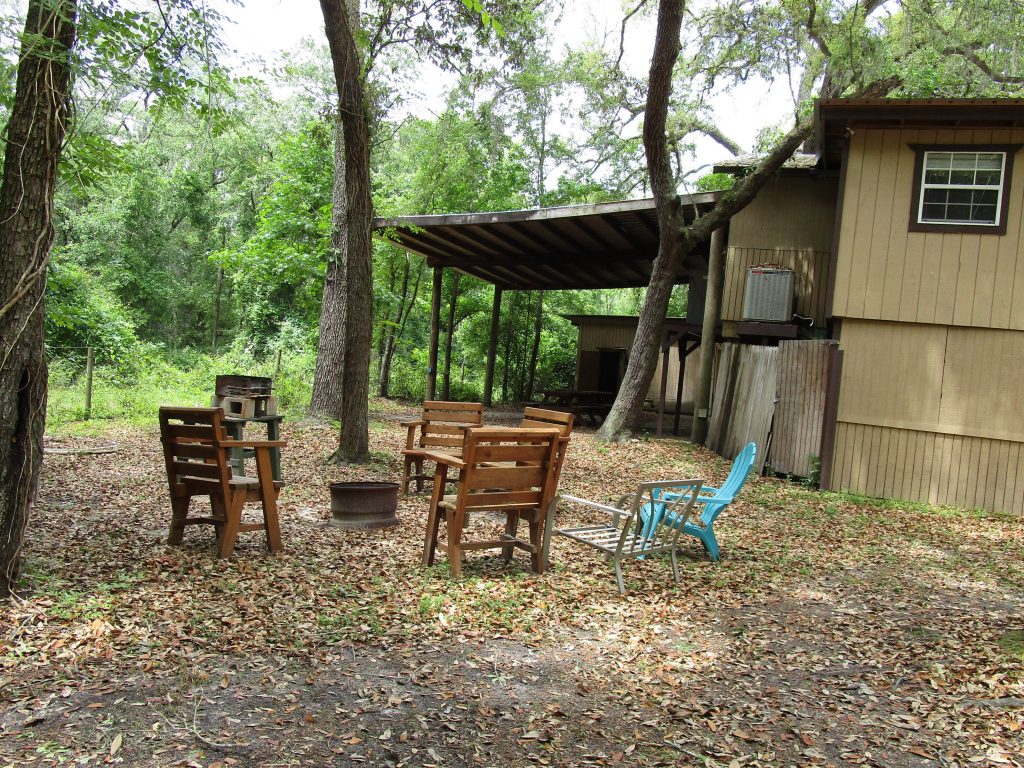 Chairs & Fire Pit Behind Tree House Cabin
