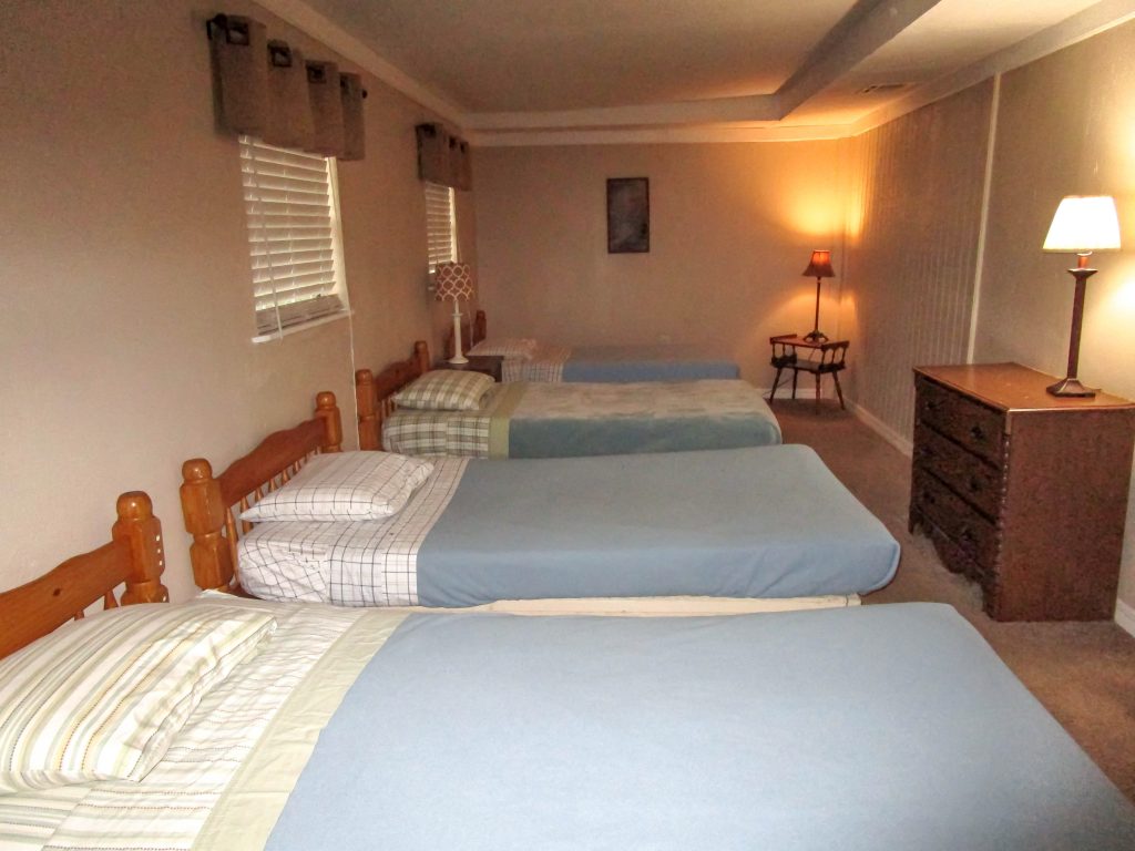 4 Twin Beds with Blue Blankets