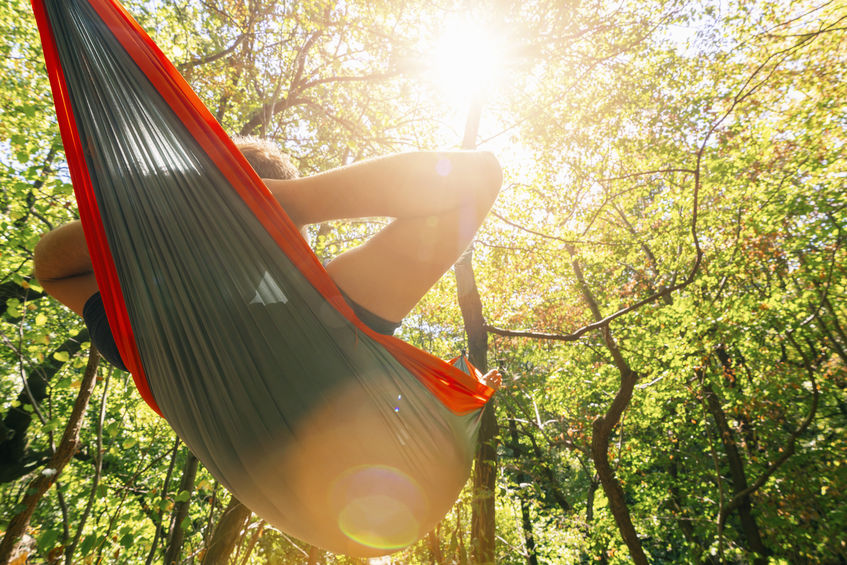 Man camping in a hammock